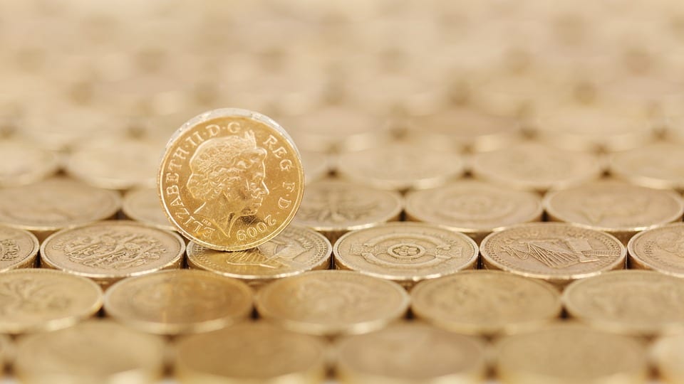 Coins layout in a pattern with one balancing across the rest.