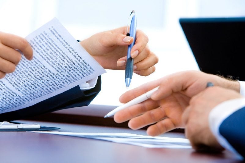 Hands with pens and documents