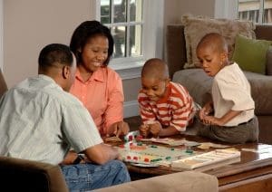Family playing a game of Monopoly