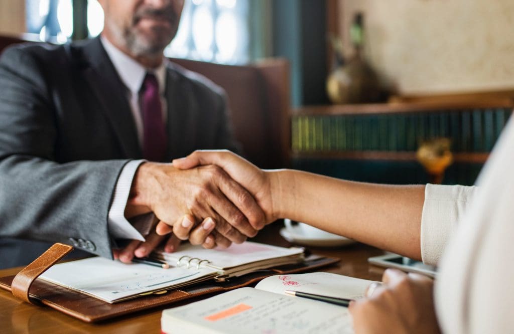 A lawyer shaking hands with his client