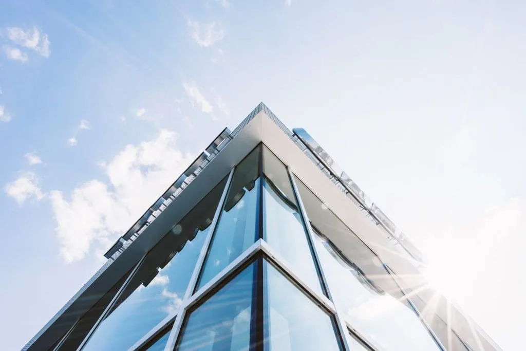 a bottom up view of the corner of an office building