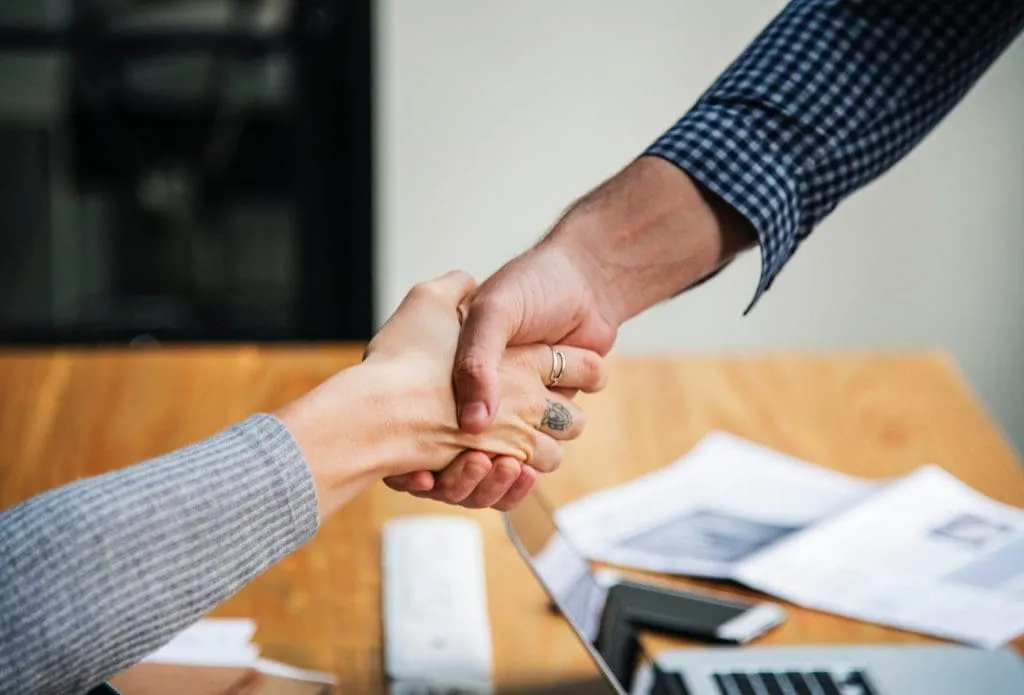 Two individuals shaking hands