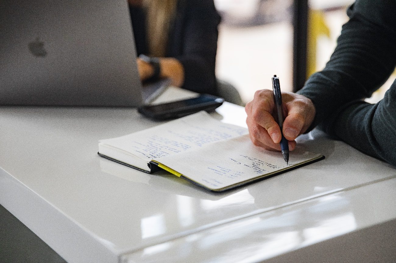 Person writing in notebook