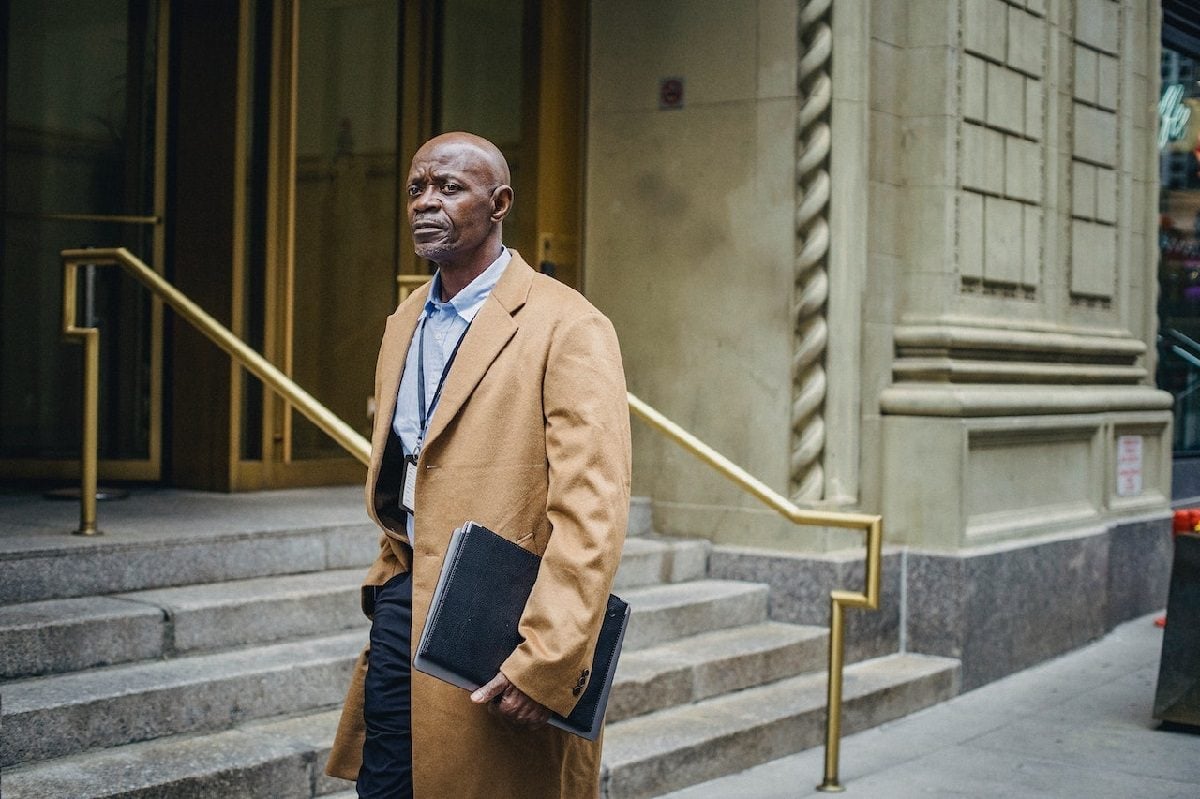 Entrepreneur with folder outside building