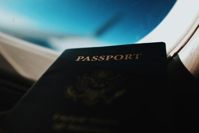 American passport by airplane window