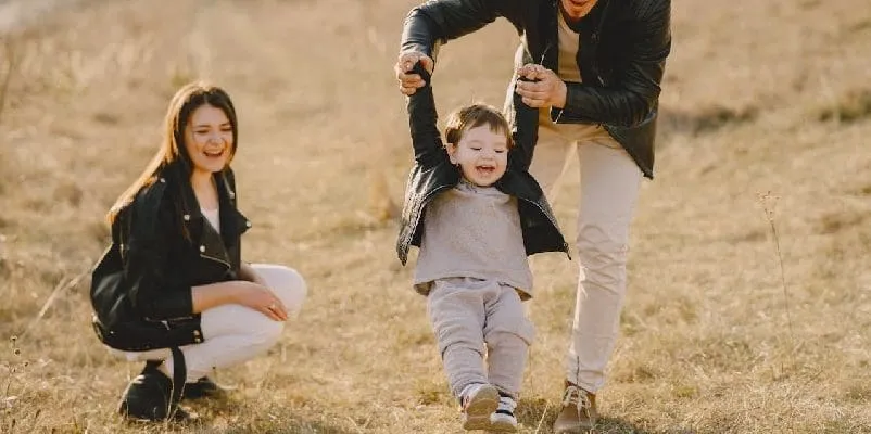 Parents playing with child, outside