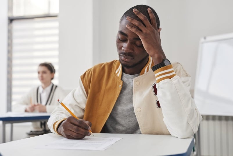 Student in class, taking a test