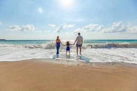 Family holding hands by sea