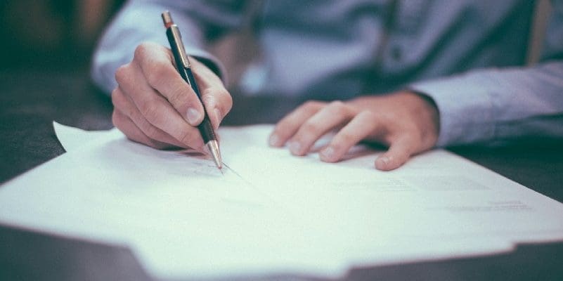 Man completing form on table