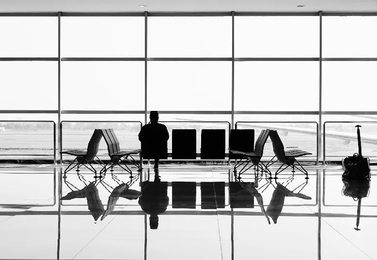 Man sitting at airport, waiting for his flight