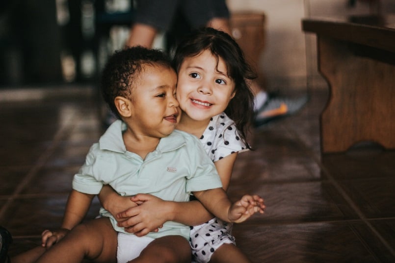 Young siblings sitting together