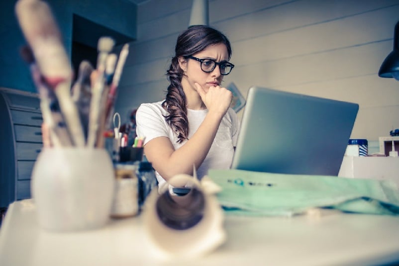 Worried woman doing research on her laptop