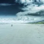 A lone person walking up the beach