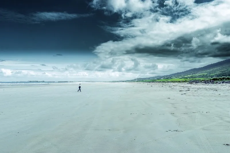 A lone person walking up the beach