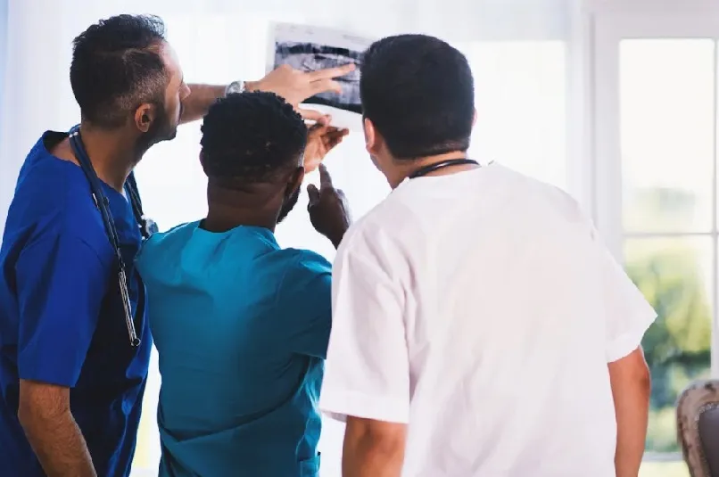 Three doctors, looking at x-ray