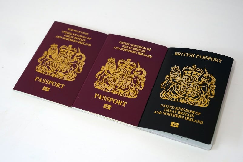 Three British passports aligned next to each other