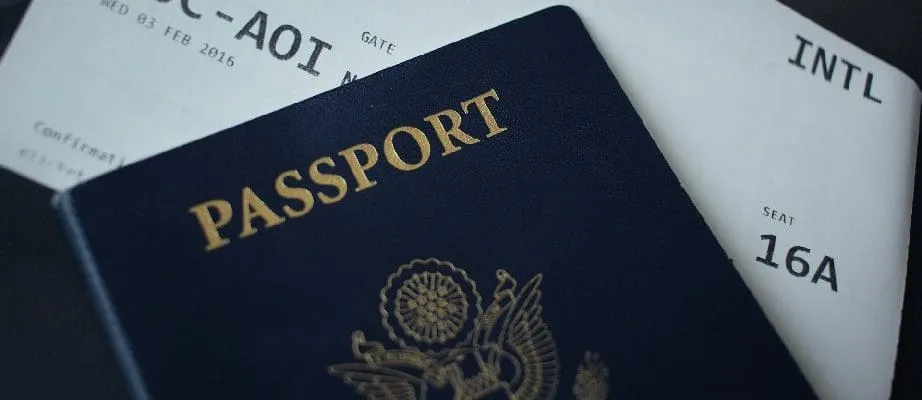 Passport on top of an airline ticket