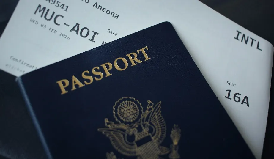 Passport on top of an airline ticket